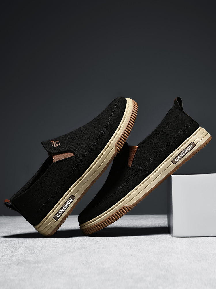 CANEMON LY553 black canvas slip-on shoes pair in an angled side view
