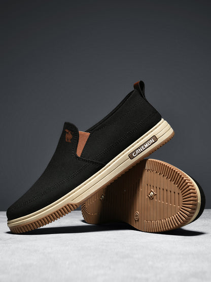 CANEMON LY553 black slip-on shoes showing the brown PVC outsole