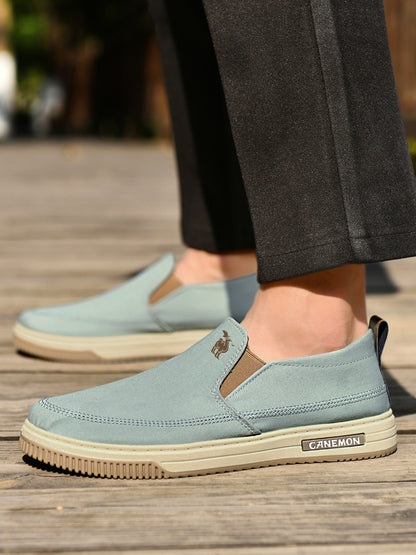 CANEMON LY553 mint green canvas slip-on shoes worn with casual trousers